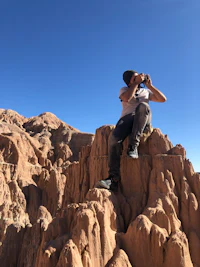 a man standing on top of a rocky cliff