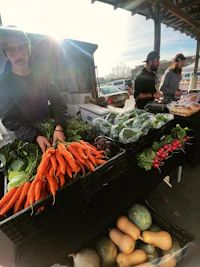 a group of people at a market selling vegetables